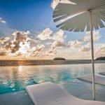 LuxeGetaways - Luxury Travel - Luxury Travel Magazine - Luxe Getaways - Luxury Lifestyle - Luxury Villa Rentals - Affluent Travel - Kata Rocks Phuket Thailand - Pools and lounge chairs at sunset